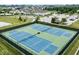 Aerial view of community tennis courts surrounded by parking and green space at 12907 Shiraz Ln, Fishers, IN 46037