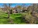 Expansive backyard with lush lawn, patio, gazebo, and mature trees creating a private oasis at 13892 Adios Pass, Carmel, IN 46032