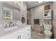 Elegant bathroom featuring a vanity with a marble countertop, with a gray tile shower at 13892 Adios Pass, Carmel, IN 46032