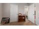 Neutral bedroom with two doors, a wood bookshelf, and framed photos at 13892 Adios Pass, Carmel, IN 46032
