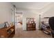 Neutral room with shelving unit and storage baskets and view into living room at 13892 Adios Pass, Carmel, IN 46032