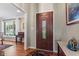 Inviting entryway featuring a dark wood front door, hardwood floors, and elegant decor at 13892 Adios Pass, Carmel, IN 46032