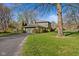 Home exterior showing a well-maintained yard, a long driveway, and mature landscaping at 13892 Adios Pass, Carmel, IN 46032