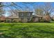 Charming two-story home featuring a well-manicured lawn and beautiful stone and siding exterior at 13892 Adios Pass, Carmel, IN 46032