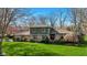 Charming two-story home with stone accents, mature trees, and a lush green lawn at 13892 Adios Pass, Carmel, IN 46032