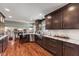 Spacious kitchen with stainless steel appliances, granite countertops, a breakfast bar, and hardwood floors at 13892 Adios Pass, Carmel, IN 46032