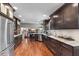 Open kitchen with stainless steel appliances, granite countertops, and hardwood floors at 13892 Adios Pass, Carmel, IN 46032