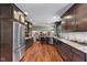 Spacious kitchen featuring wood floors, stainless steel appliances and dark wood cabinets at 13892 Adios Pass, Carmel, IN 46032