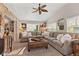 Comfortable living room with vaulted ceilings, a stone accent wall, and large windows for natural light at 13892 Adios Pass, Carmel, IN 46032