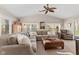 Bright living room with vaulted ceiling, large windows, and a comfortable sectional sofa at 13892 Adios Pass, Carmel, IN 46032