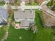 Overhead view of a home showcasing a large, green backyard, a patio area, and mature trees for ultimate privacy at 14910 Declaration Dr, Westfield, IN 46074