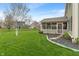 Green backyard featuring a screened-in porch and a tree, creating a private outdoor retreat at 14910 Declaration Dr, Westfield, IN 46074