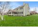 Grassy backyard showcasing a screened-in porch and mature trees, creating a serene outdoor space at 14910 Declaration Dr, Westfield, IN 46074