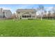 Spacious backyard with lush green grass, mature trees, and a screened-in porch, perfect for outdoor enjoyment at 14910 Declaration Dr, Westfield, IN 46074