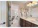 Well-lit bathroom featuring a double vanity, a framed mirror, and a doorway to the hall at 14910 Declaration Dr, Westfield, IN 46074