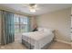 Cozy bedroom featuring a plush bed, a window with floral curtains, and soft, neutral decor at 14910 Declaration Dr, Westfield, IN 46074
