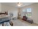 Neutral bedroom features a ceiling fan and a bright window, offering a calm and inviting atmosphere at 14910 Declaration Dr, Westfield, IN 46074