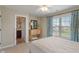 Bedroom with ceiling fan, and a bright window with floral curtains, next to the bathroom at 14910 Declaration Dr, Westfield, IN 46074