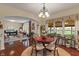 Bright dining area with hardwood floors open to the living room and screened porch at 14910 Declaration Dr, Westfield, IN 46074