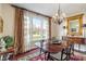 Formal dining room with a large window, elegant chandelier, and classic furnishings at 14910 Declaration Dr, Westfield, IN 46074