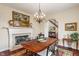 Elegant dining room featuring a fireplace, chandelier, and hardwood floors at 14910 Declaration Dr, Westfield, IN 46074
