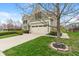 View of the side of the house with the garage and part of the beautifully landscaped yard at 14910 Declaration Dr, Westfield, IN 46074