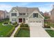 Charming two-story home with a manicured lawn, a two-car garage, and classic architectural details at 14910 Declaration Dr, Westfield, IN 46074