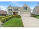 Beautiful two-story home featuring a well-maintained lawn, a two-car garage, and classic design elements at 14910 Declaration Dr, Westfield, IN 46074