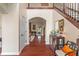 Elegant foyer with hardwood floors, an open archway, and decorative furnishings at 14910 Declaration Dr, Westfield, IN 46074