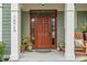 Close-up of the front door surrounded by decorative plants and a charming wooden bench at 14910 Declaration Dr, Westfield, IN 46074