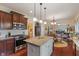 Open kitchen with stainless appliances, center island, and breakfast bar at 14910 Declaration Dr, Westfield, IN 46074