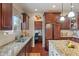 Kitchen with granite countertops, dark wood cabinets, and a view to an office at 14910 Declaration Dr, Westfield, IN 46074