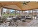 Relaxing sunroom with comfortable seating, ceiling fan, stone floors, and scenic outdoor views at 14910 Declaration Dr, Westfield, IN 46074