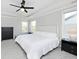 Well-lit bedroom featuring a comfortable bed, dark dressers, and a modern ceiling fan at 15341 Montfort Dr, Noblesville, IN 46062