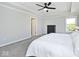 Bright bedroom with a large bed, neutral carpet, and a modern ceiling fan at 15341 Montfort Dr, Noblesville, IN 46062
