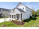 Side view of a lovely two-story home featuring a cozy front porch and manicured lawn at 15341 Montfort Dr, Noblesville, IN 46062