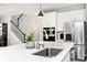 Bright kitchen with stainless steel appliances, white cabinets, and a quartz countertop island, perfect for cooking and entertaining at 15341 Montfort Dr, Noblesville, IN 46062