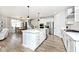 Open-concept kitchen with stainless appliances, white island, and adjacent dining and living areas, creating an inviting space at 15341 Montfort Dr, Noblesville, IN 46062