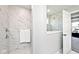 Elegant shower with marble-style tiles and glass enclosure leading to a bathroom and bedroom at 15341 Montfort Dr, Noblesville, IN 46062
