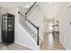 Elegant staircase with black and white accents, leading to the upper level at 15341 Montfort Dr, Noblesville, IN 46062