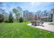 Expansive backyard featuring a concrete patio with outdoor seating and a lush lawn, perfect for entertaining at 15762 Hargray Dr, Noblesville, IN 46062