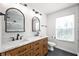 Bright bathroom features double sink vanity, wood cabinets, matte black fixtures, and a toilet at 15762 Hargray Dr, Noblesville, IN 46062