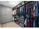 Walk-in closet featuring custom shelving, drawers, ample hanging space, and vinyl flooring at 15762 Hargray Dr, Noblesville, IN 46062
