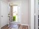 Bright entryway with hardwood floors, a transom window above the front door, and a view of the exterior at 15762 Hargray Dr, Noblesville, IN 46062