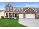 Charming two-story home featuring a manicured lawn and a convenient two-car garage at 15762 Hargray Dr, Noblesville, IN 46062