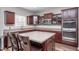 Kitchen with stainless steel appliances, a center island with seating, and cherry wood cabinets at 15762 Hargray Dr, Noblesville, IN 46062
