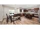 Spacious kitchen and dining area with hardwood floors and modern dark wood cabinets at 15762 Hargray Dr, Noblesville, IN 46062