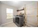 Bright laundry room with modern washer and dryer, storage shelf, and drying rack at 15762 Hargray Dr, Noblesville, IN 46062