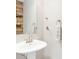 Half bath with pedestal sink and wood-accented wall providing a rustic charm at 15762 Hargray Dr, Noblesville, IN 46062