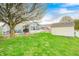 Spacious backyard featuring a well-maintained lawn, patio, and shed, perfect for outdoor enjoyment at 1614 Ashley Dr, Lebanon, IN 46052